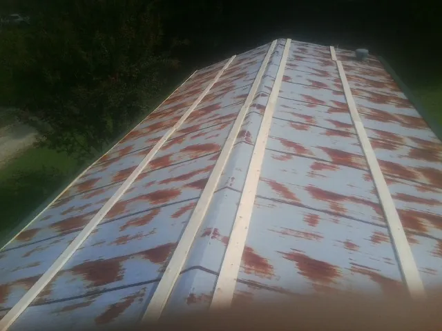 Rusted metal roof panels with new wood purlins before replacement — Storm Damage Roof Repair in Umatilla by Roofing Brothers